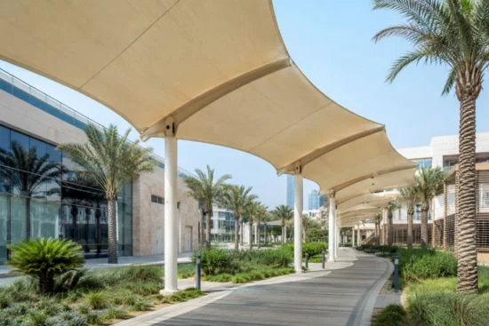 Modern covered walkway shade structure connecting commercial buildings in the UAE